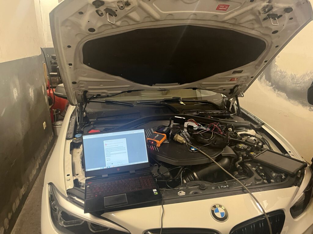Laptop connected to a BMW M140i engine for Stage 2 tuning